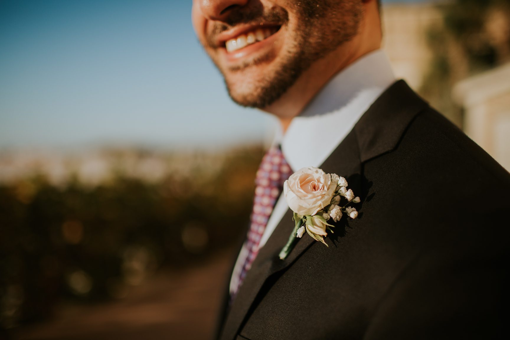 groom to be's smile and boutonniere