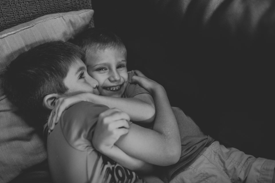 cuddling brothers during in-home session